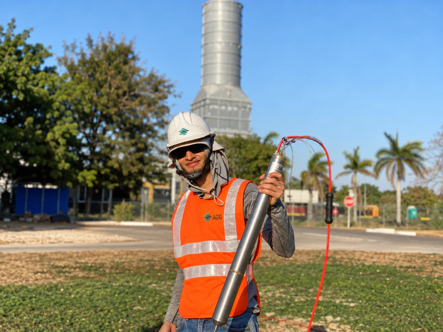 AGG geophysicist holding a borehole seismic instrument