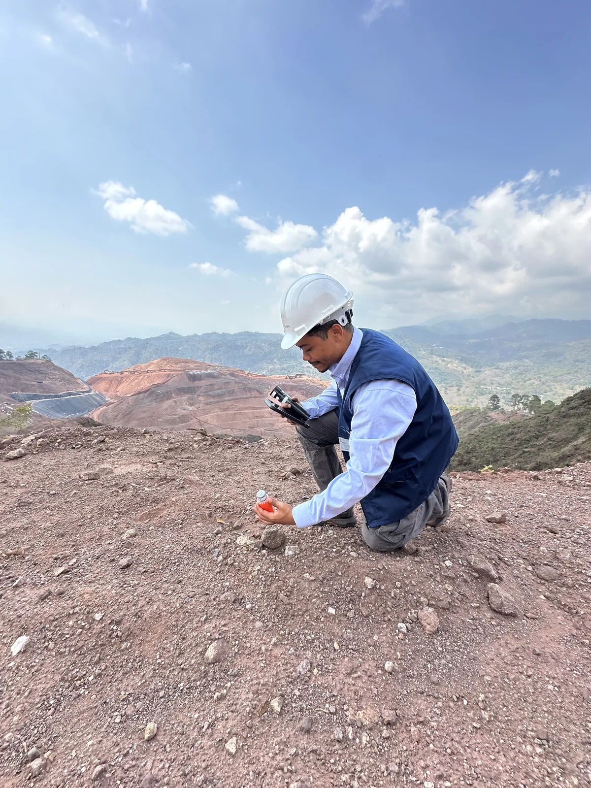 AGG geophysicist taking a field measurement at a mine